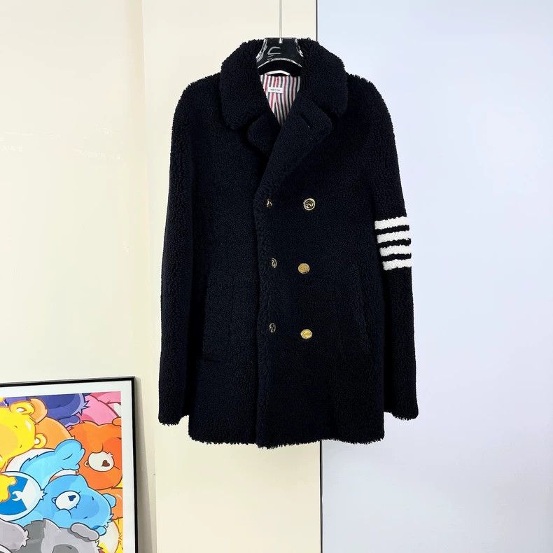 Thom Browne A coat with fur and feathers