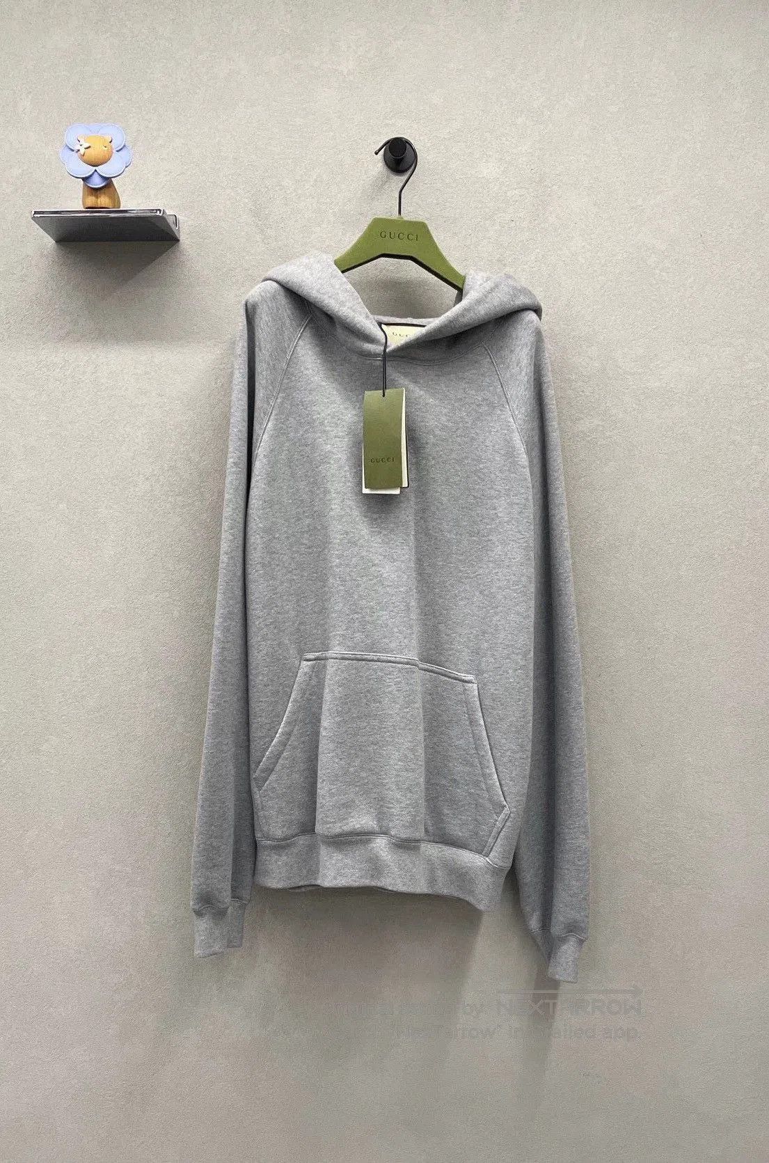 gray gucci hoodie with logo.