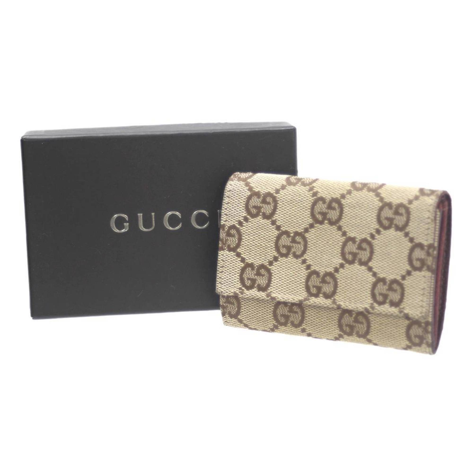 image of Gucci Coin Case GG Canvas in Brown, Women's