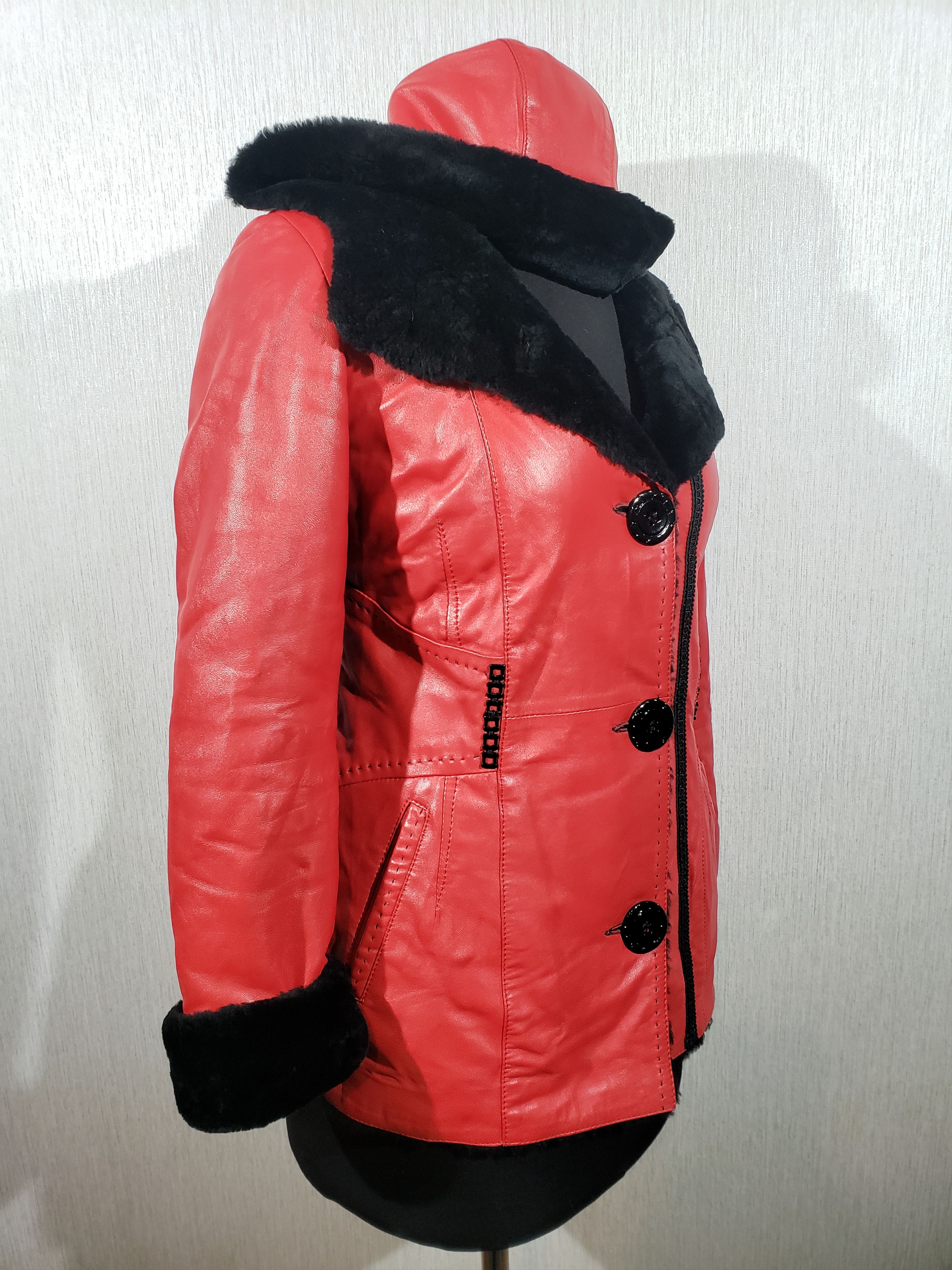 Stylish women's red sheepskin coat with a hood. Fur Faux Fur