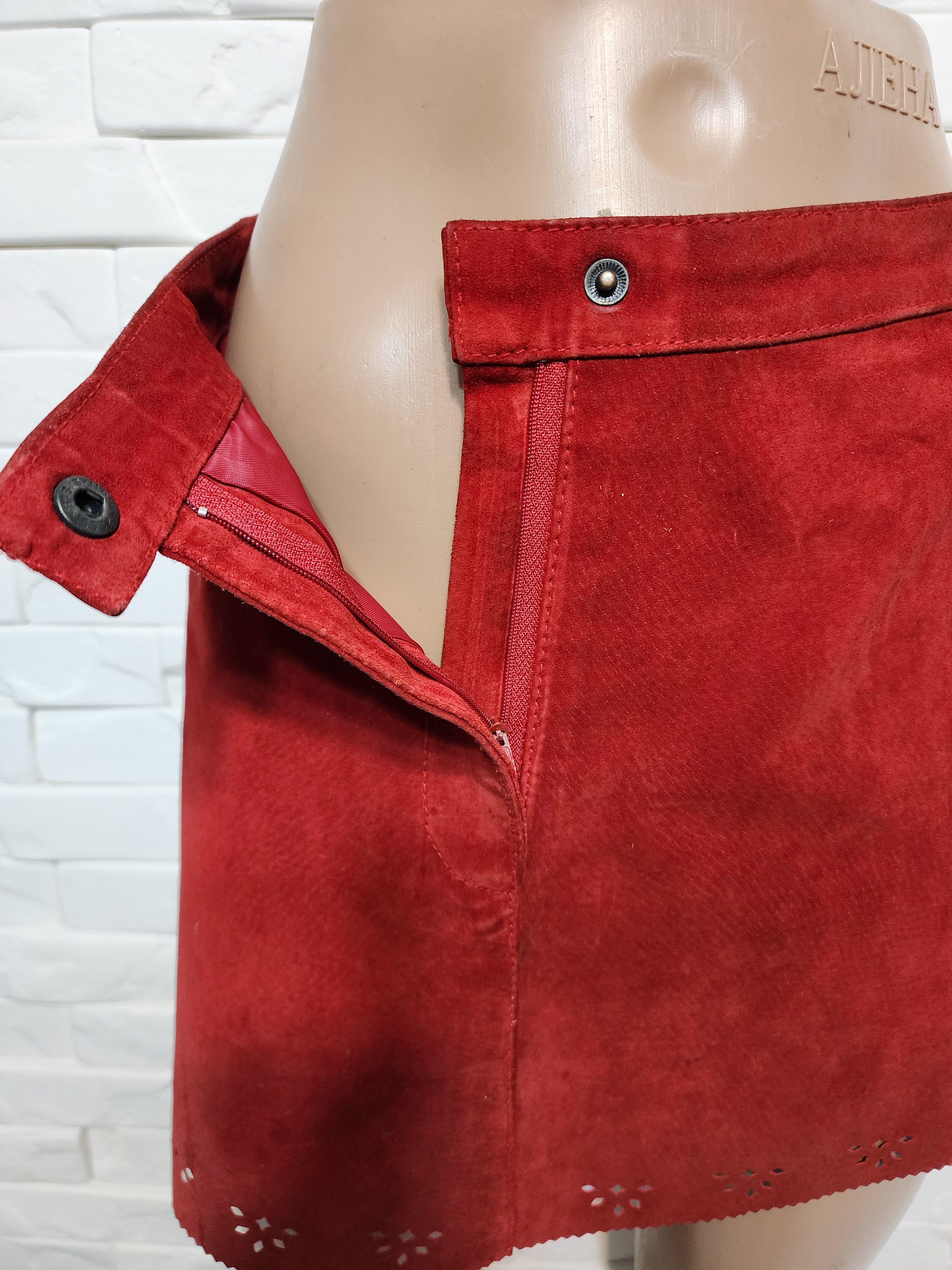 Red skirt made of genuine suede with perforation.