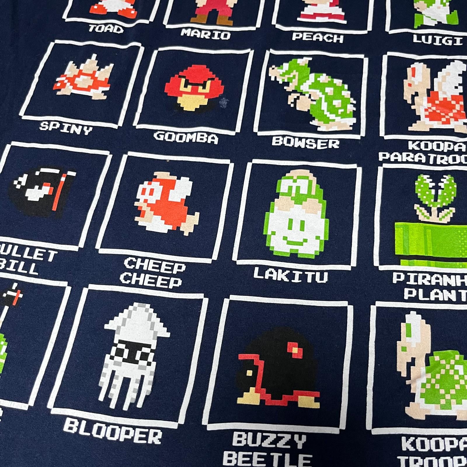 Other 🎮 Super Mario Bros. Pixel Character Grid Tee – Size M Size US M / EU 48-50 / 2 - 4 Thumbnail