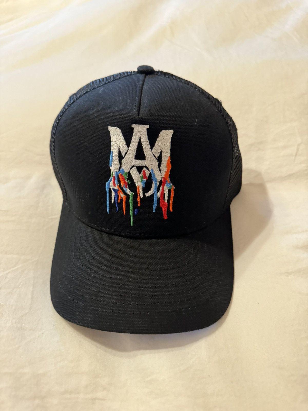image of Amiri Embroidered Paint Drip Am Logo Trucker Snapback Hat in Black, Men's