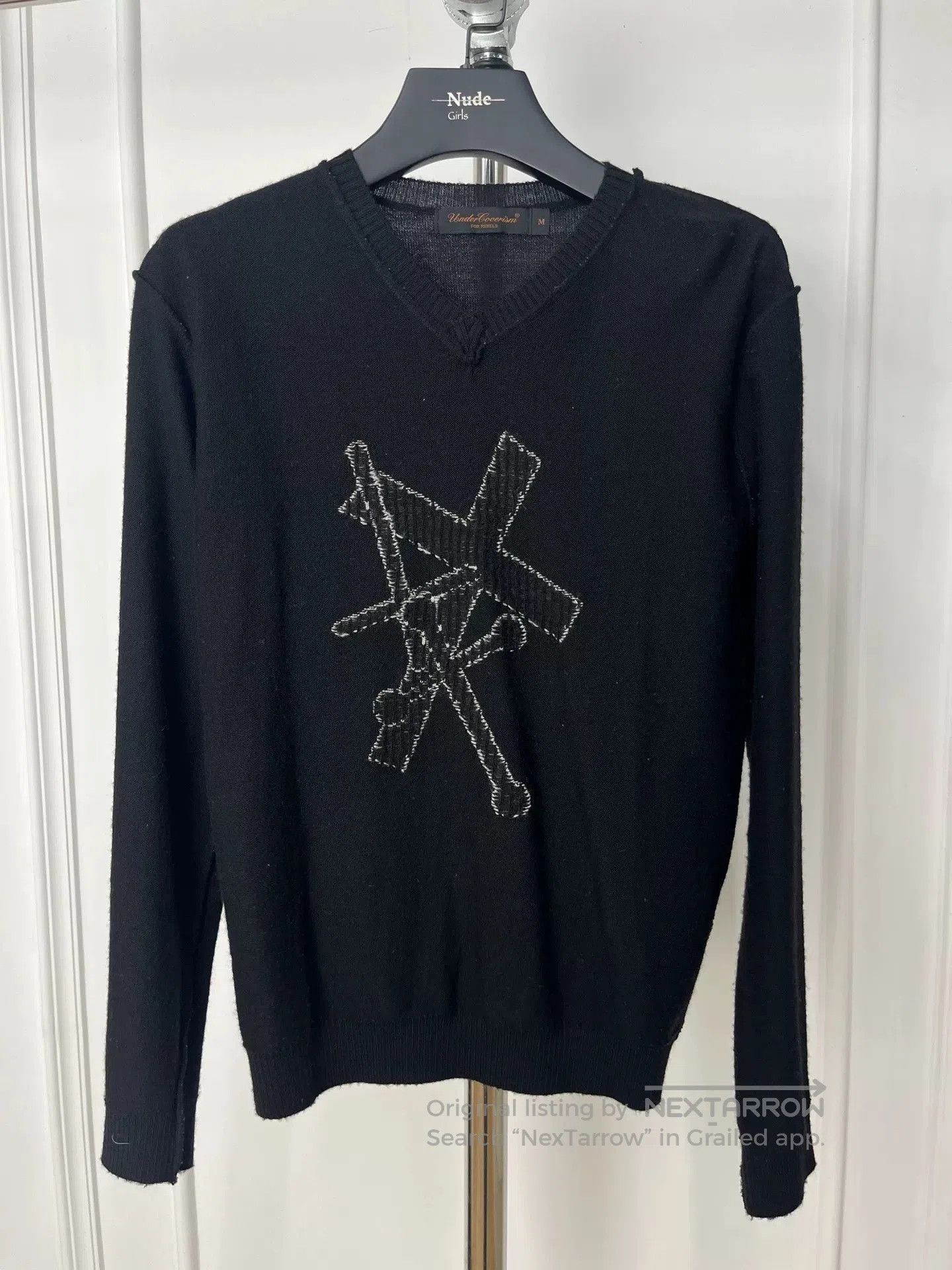 black knit sweater with unique design.