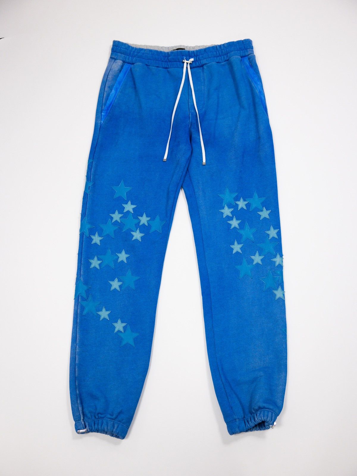 image of Amiri Pigment Spray Star Sweatpants in Blue, Men's (Size 36)