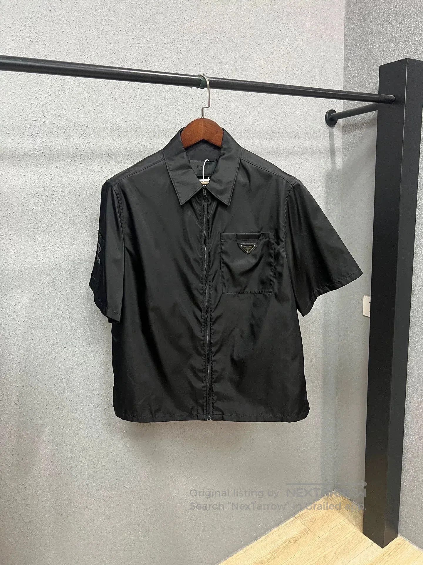 black zip-up nylon short sleeve shirt.