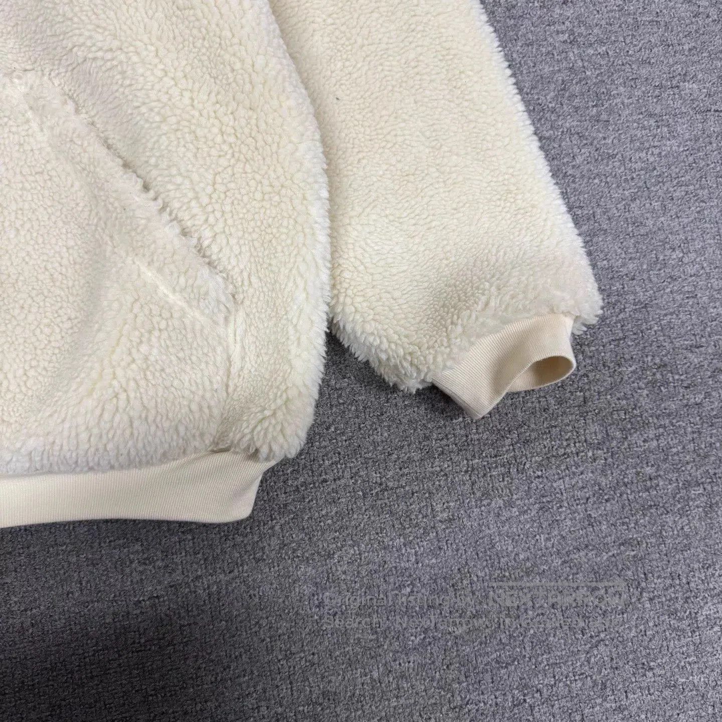 Beige Zip-Up Fleece Hoodie with Hood and Pockets.