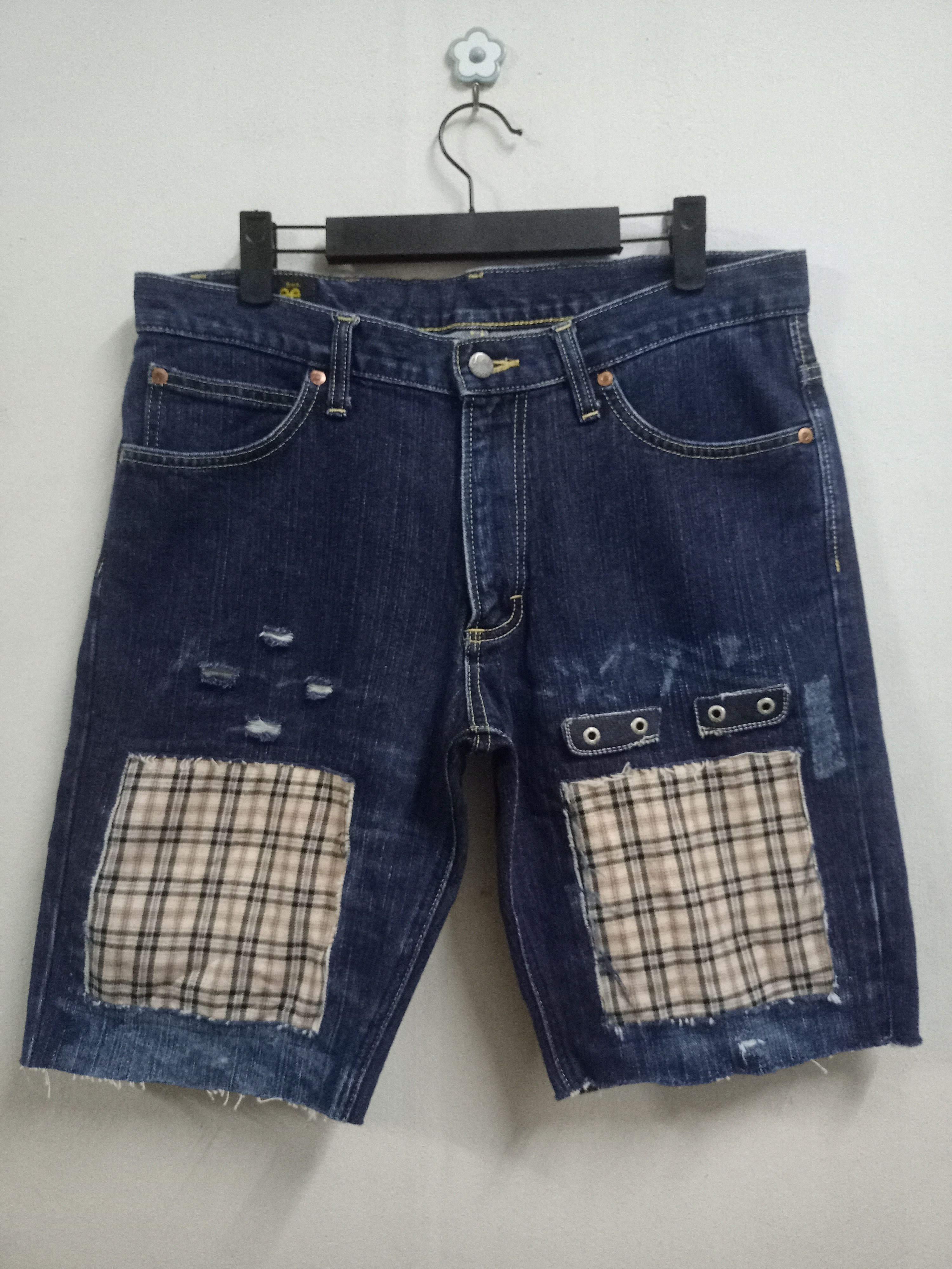 Image of Avant Garde x Distressed Denim Vintage Lee Riders Distressed Patched Jean Shorts in Blue (Size 33)