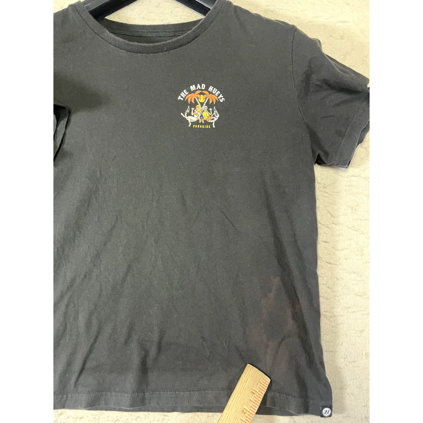 Vintage The Mad Hueys T-Shirt Black Graphic Print What Happens In Paradise Medium Mens Reg Crew Neck Short Sleeve Cotton Graphic Print Size US M / EU 48-50 / 2 - 6 Thumbnail