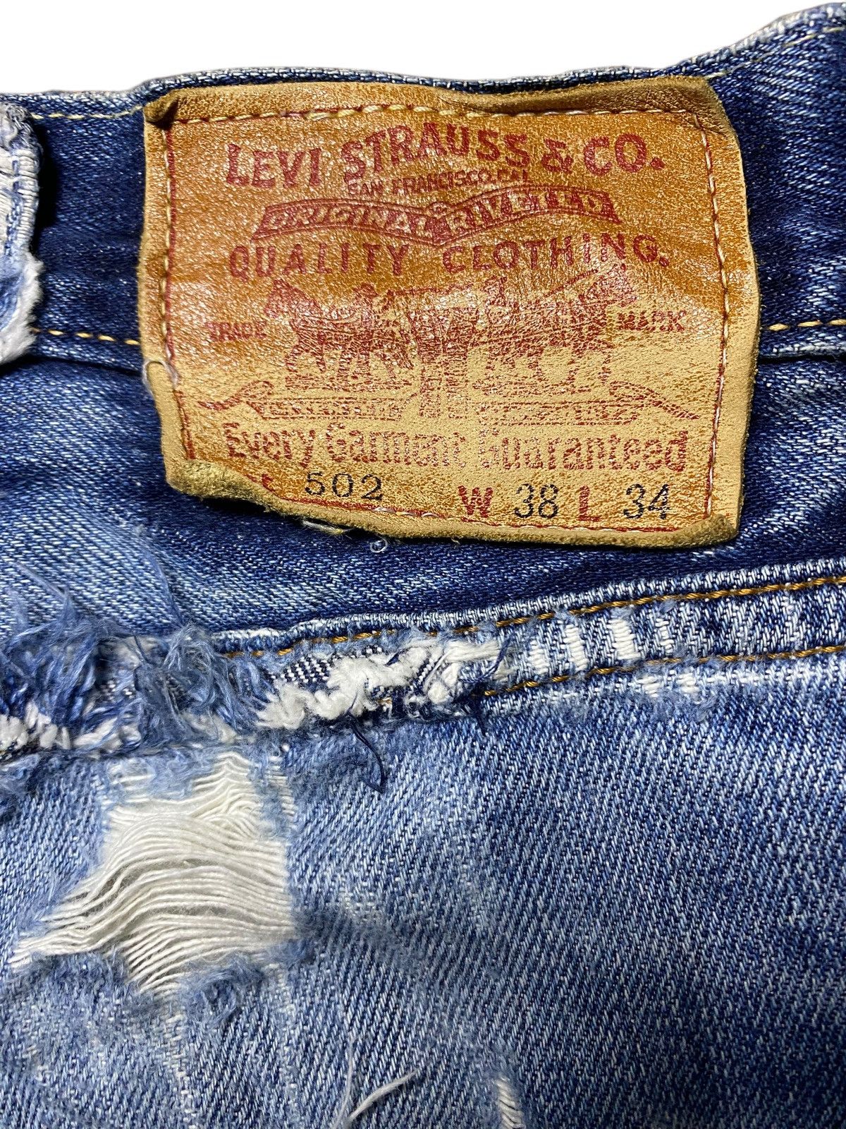 Vintage Levis 502 Blue Wash Ripped Straight Jeans