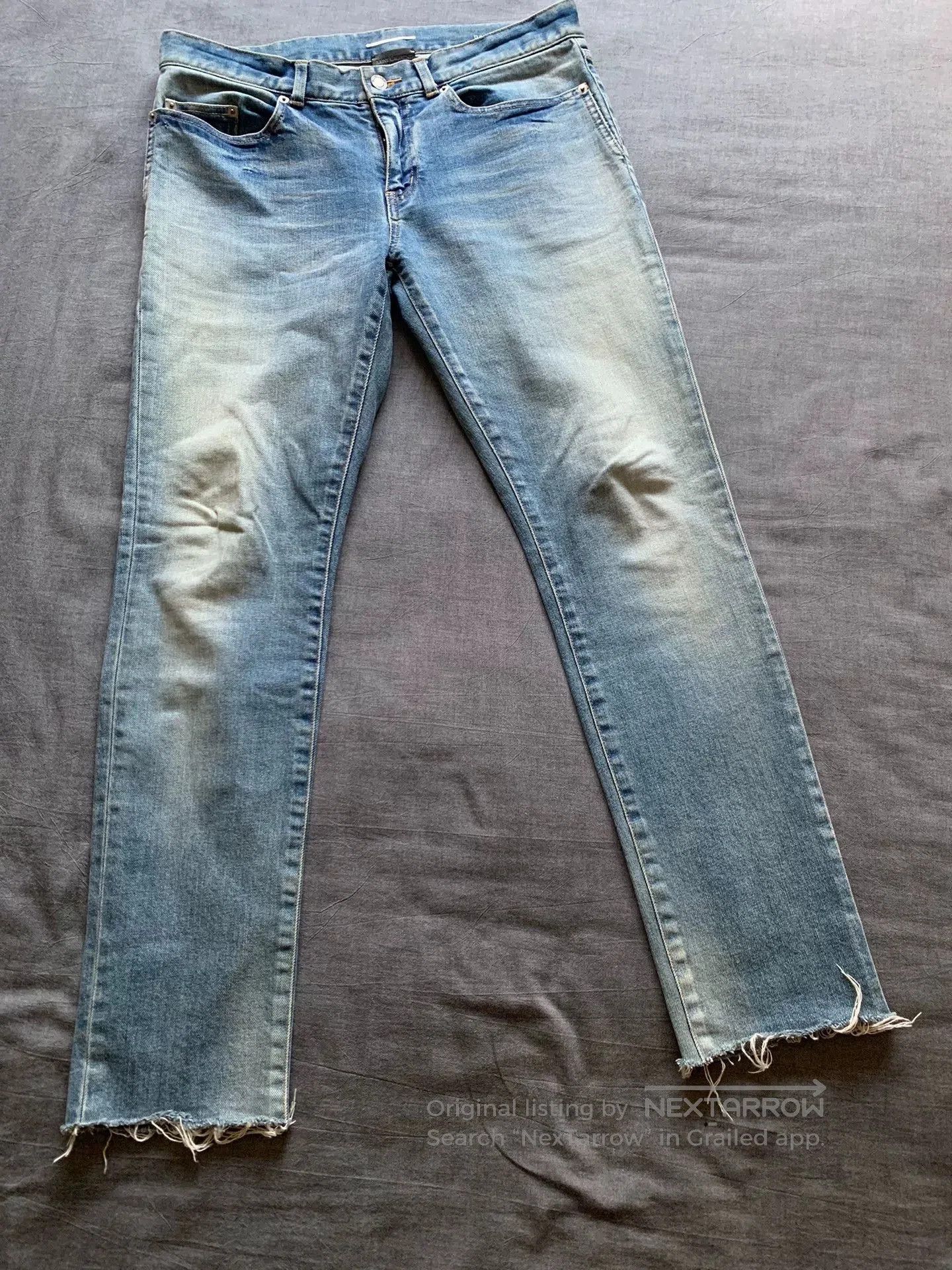 SAINT LAURENT Washed Frayed Jeans.