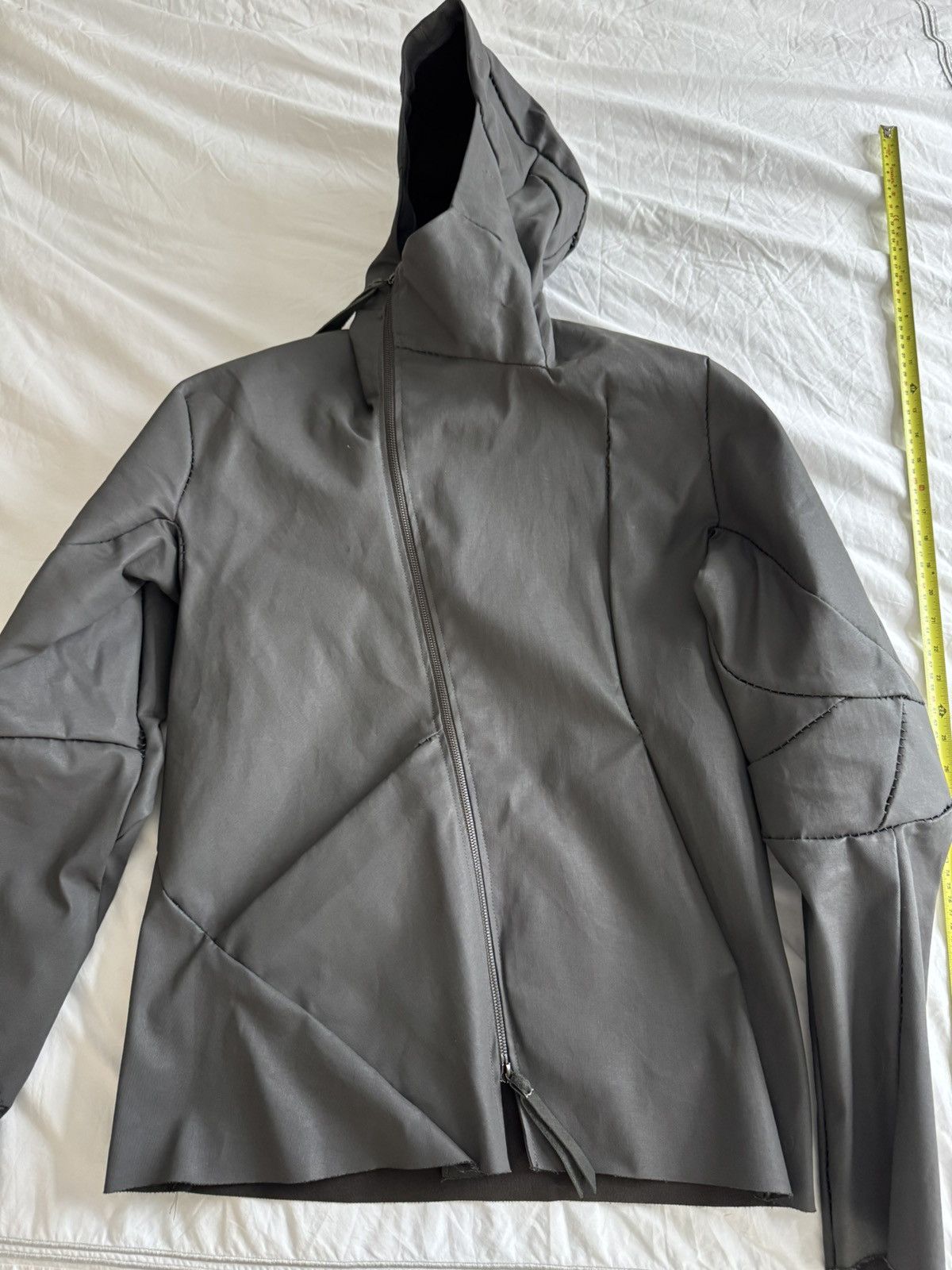 Unlined hand stitched hooded jacket.