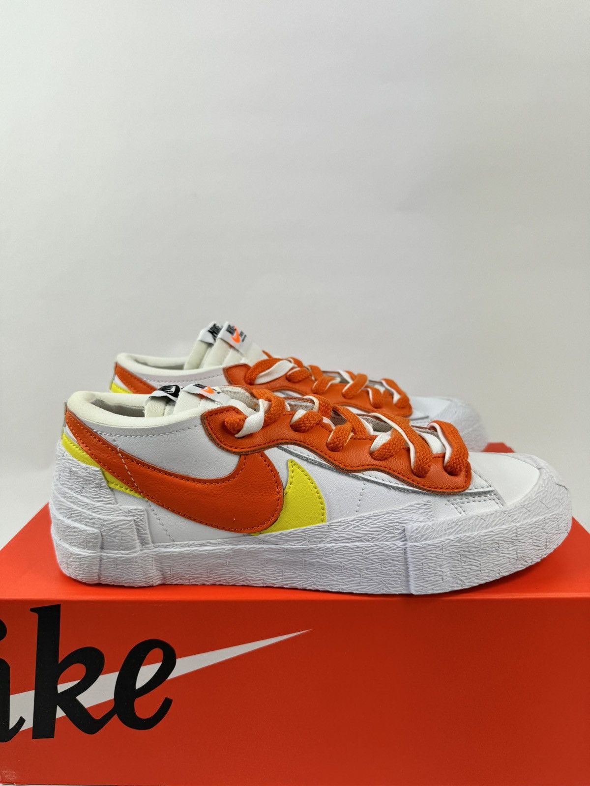 image of Nike Blazer Low Sacai Sneakers in Orange/White, Men's (Size 7)