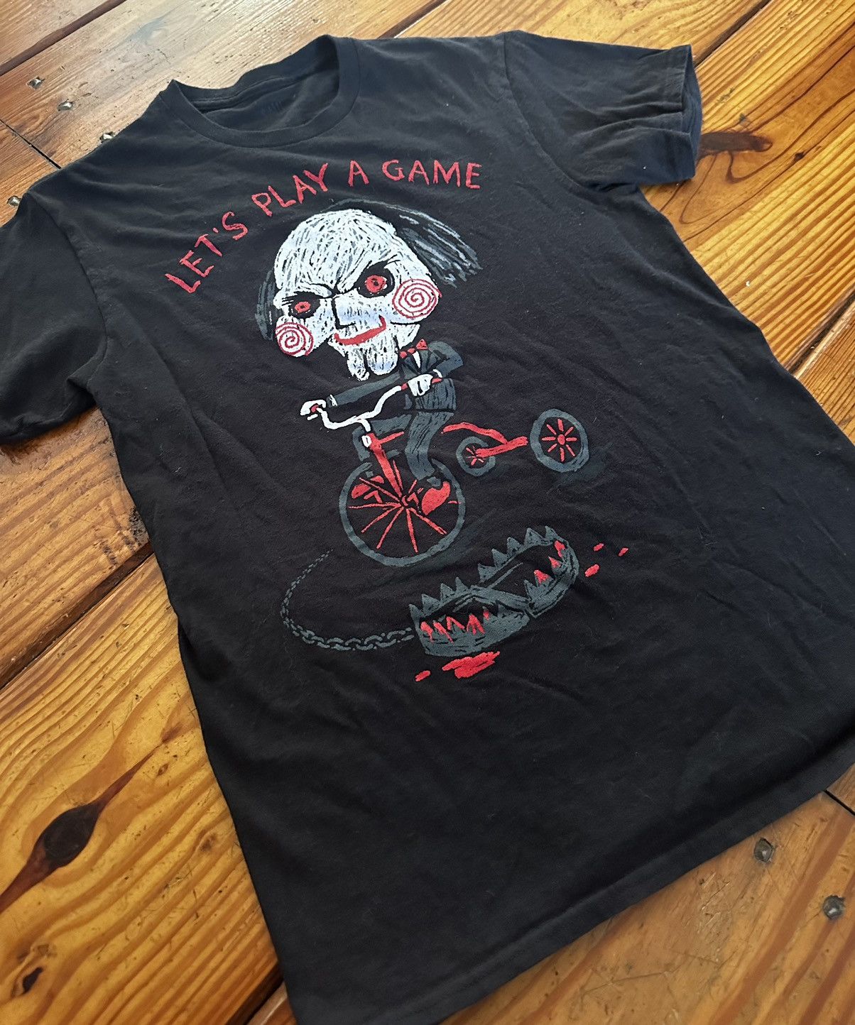 image of Band Tees x Movie Saw “Let’S Play A Game” Tee in Black, Men's (Size Small)