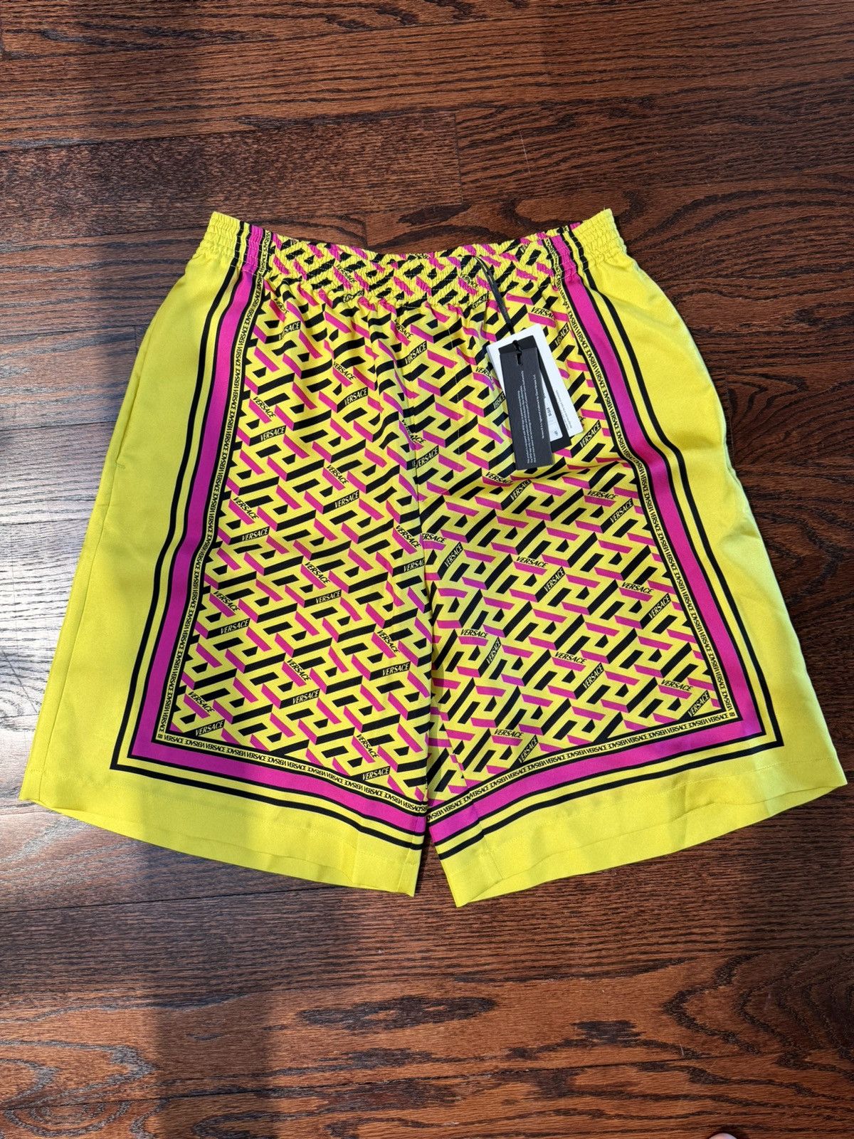 Image of Versace La Greca Monogram Print Silk Shorts in Yellow, Men's (Size 36)