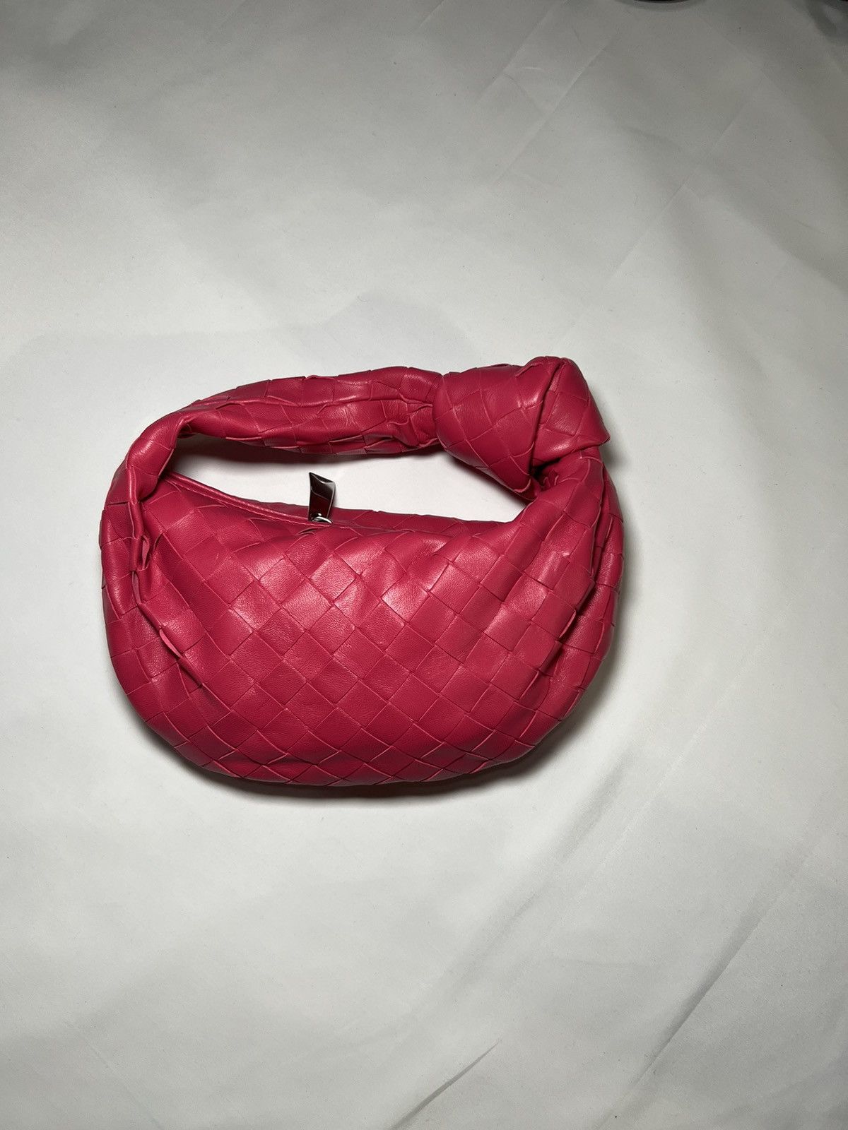 image of Bottega Veneta Jodie Mini Napa Leather Intrecciato in Cranberry, Women's