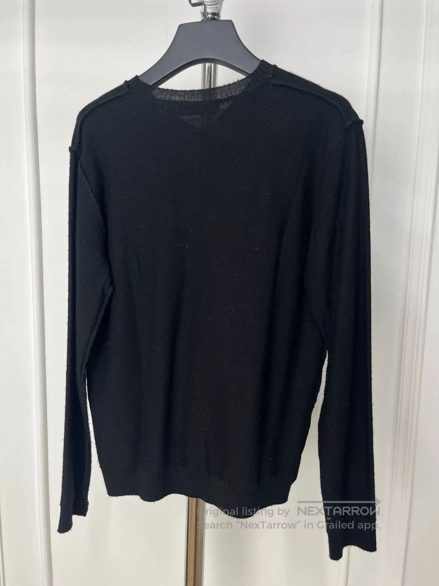 black knit sweater with unique design.