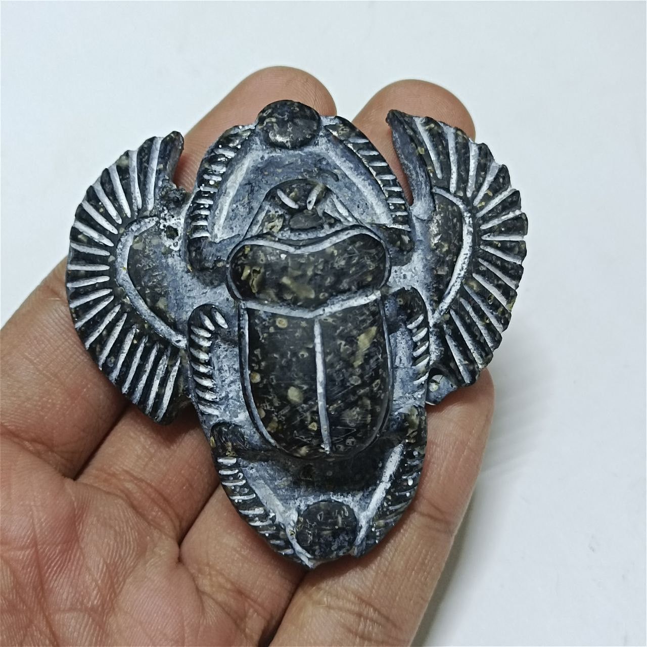 Carved Egyptian scarab piece in ancient archaeological style