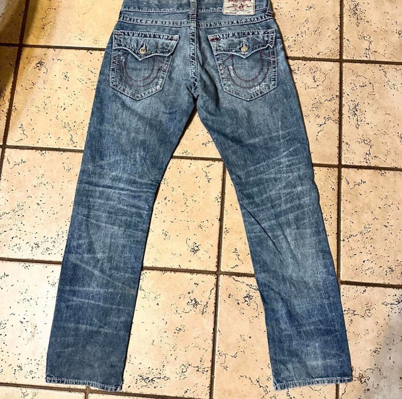 Light blue true religion jeans with pink stitching