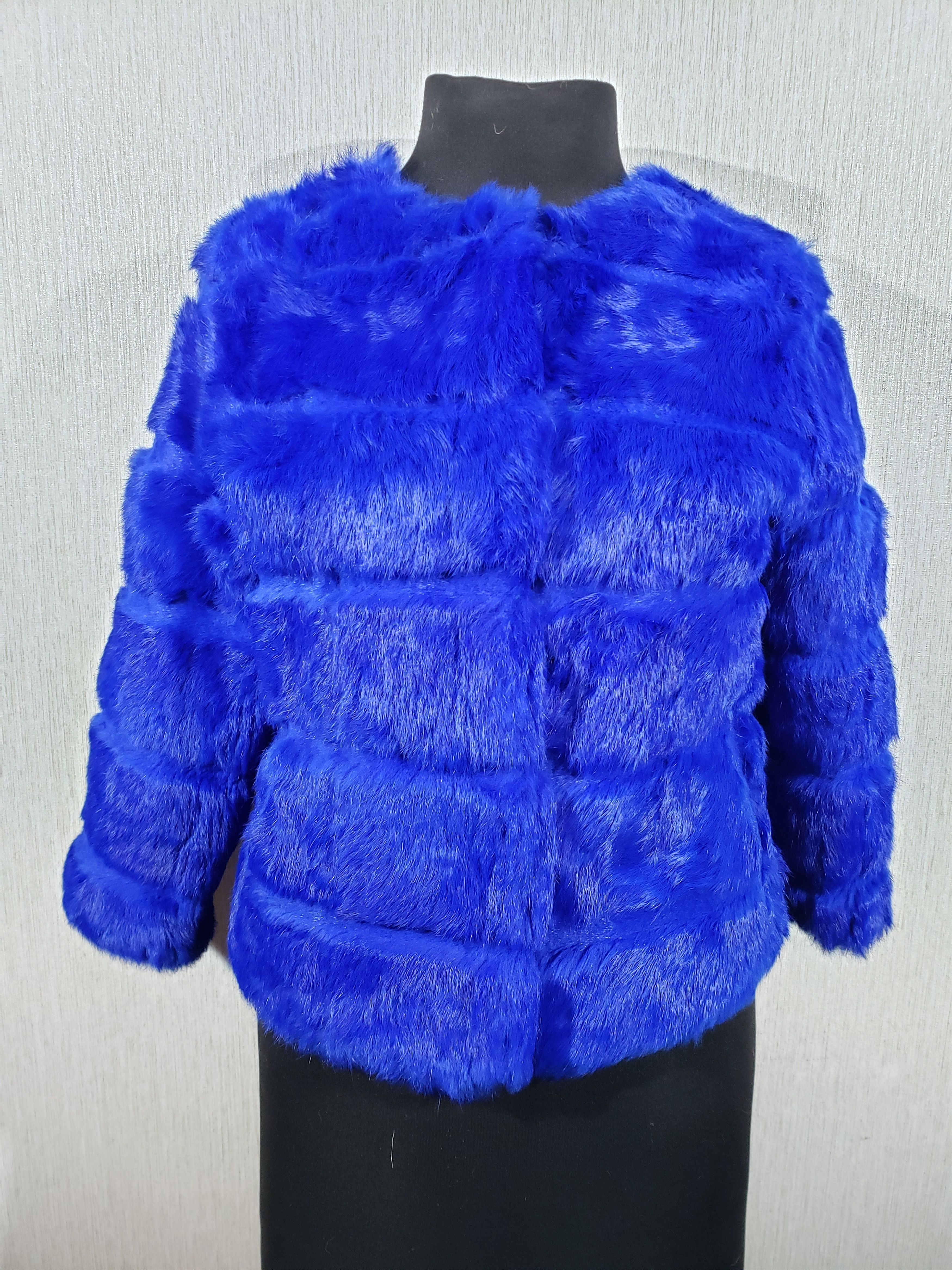 Warm women's blue fur coat with short sleeves.