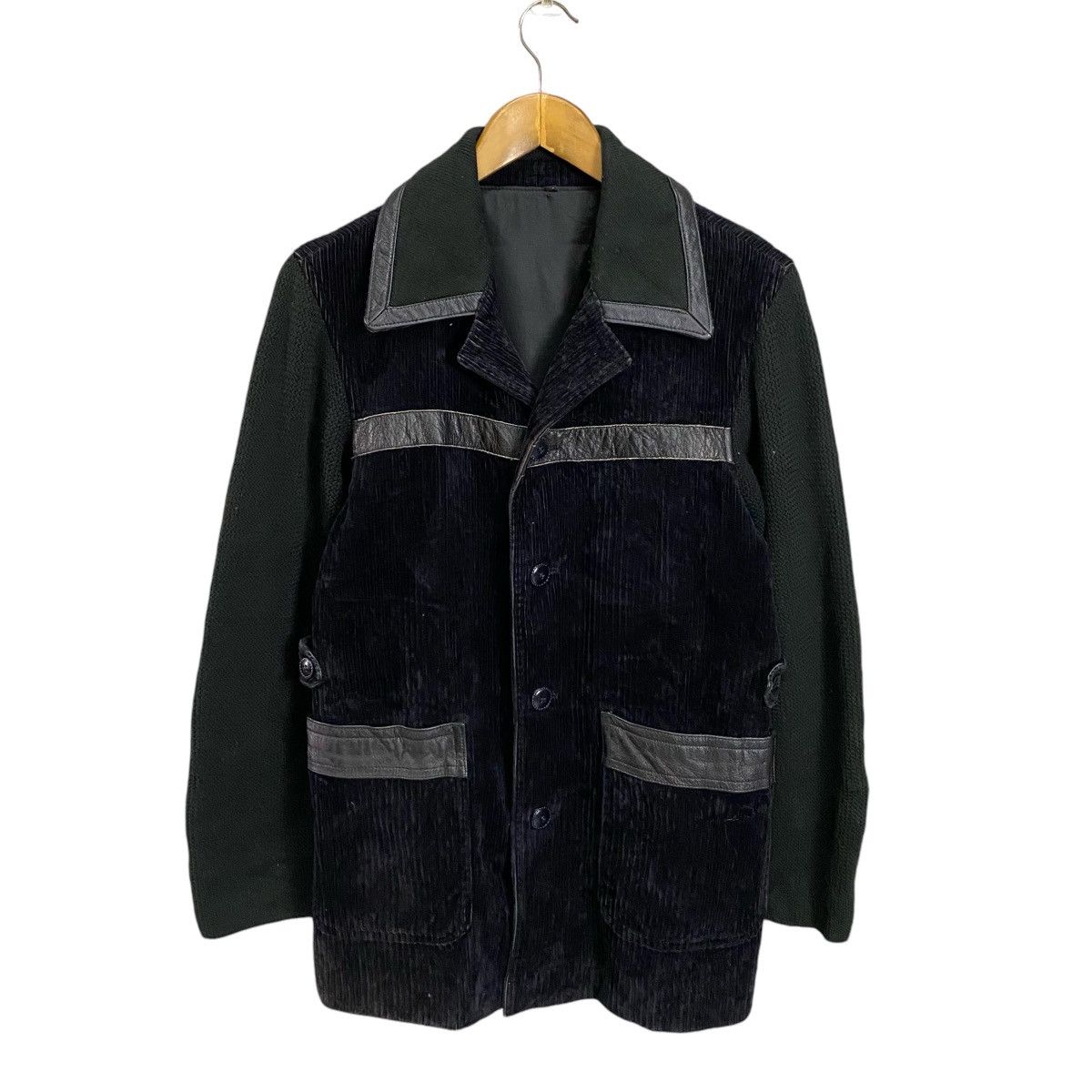Black corduroy sahariana with leather inserts.