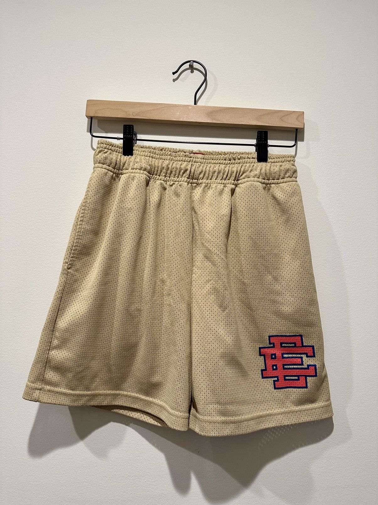 Tan shorts with peach logo