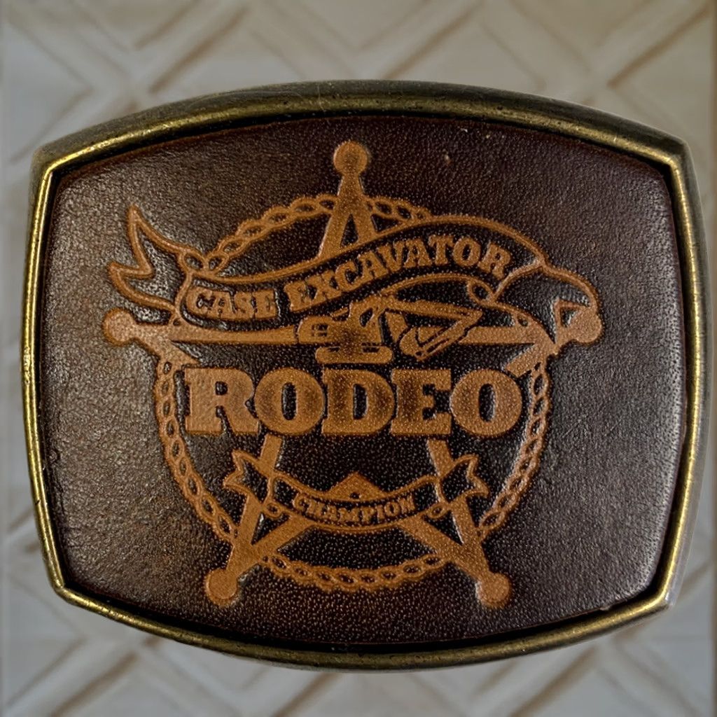 Vintage EL CID VINTAGE 1970s CASE EXCAVATOR RODEO CHAMPION BELT BUCKLE Unisex Adults Brass Plated / Leather Insert 1.85" Fits 3.10"(w) x 2.60"(h) Belt Width Size ONE SIZE - 1 Thumbnail