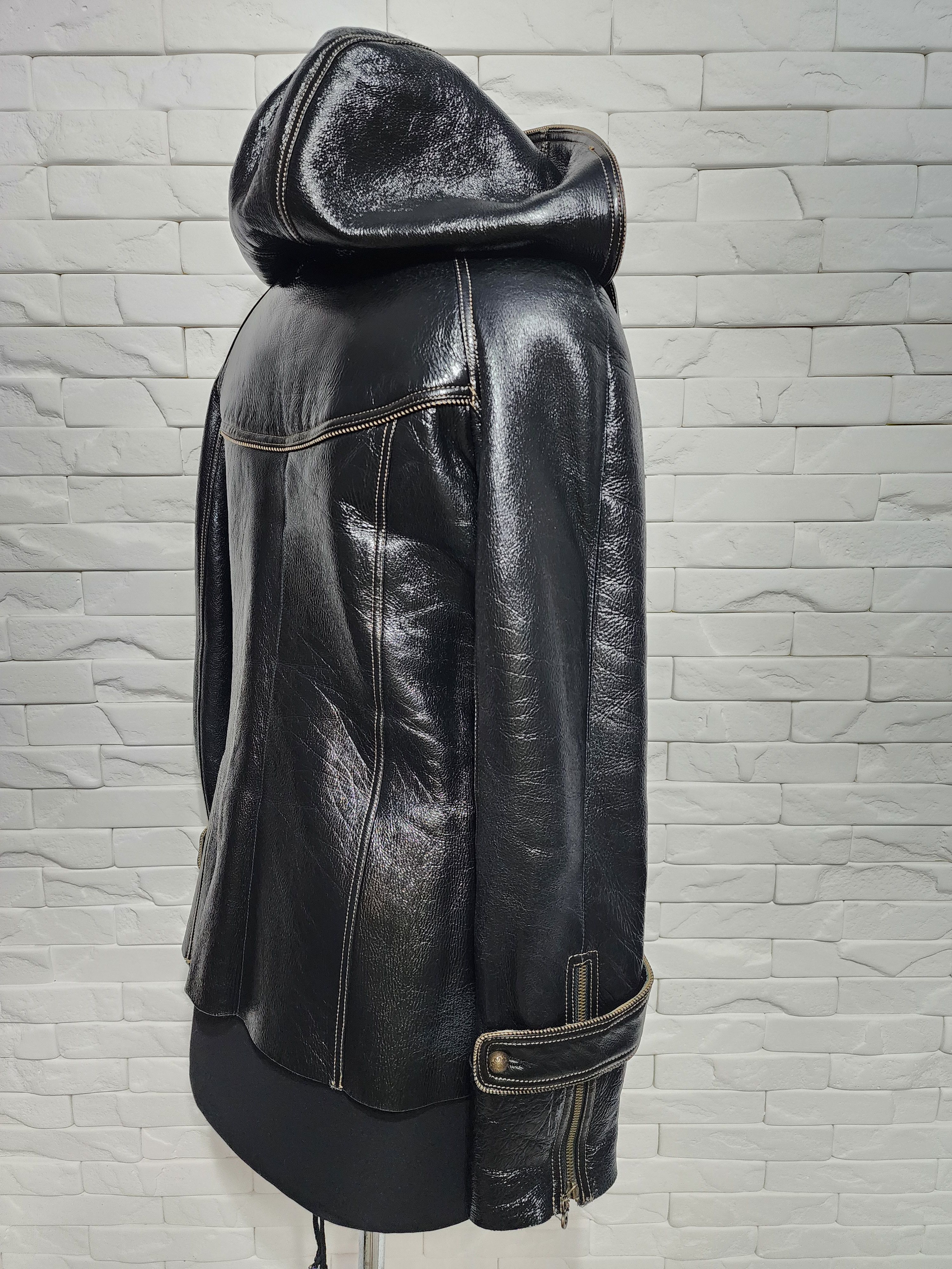 Black sheepskin coat with a metal zipper and hood.