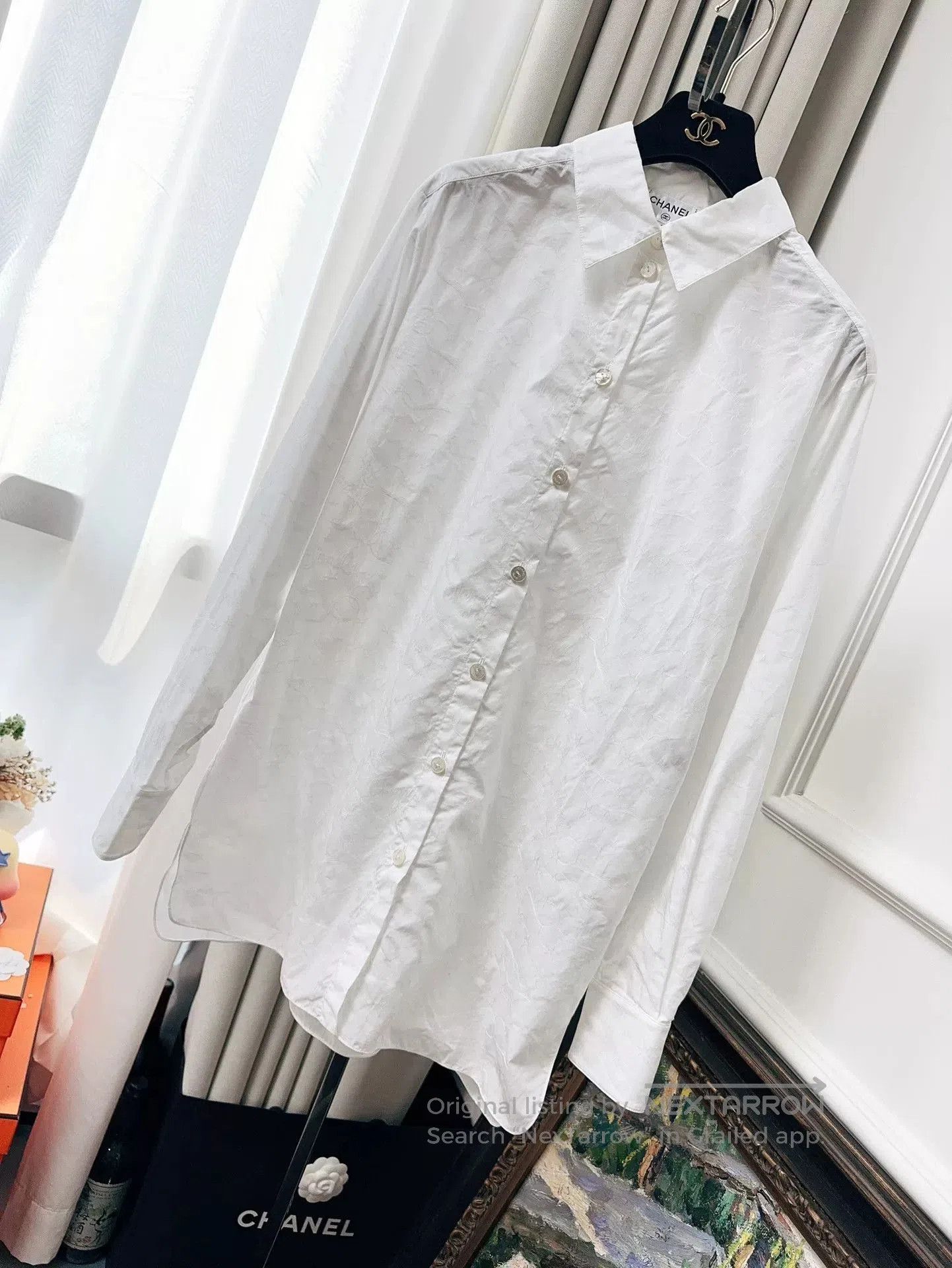 white long sleeve shirt with star logo.