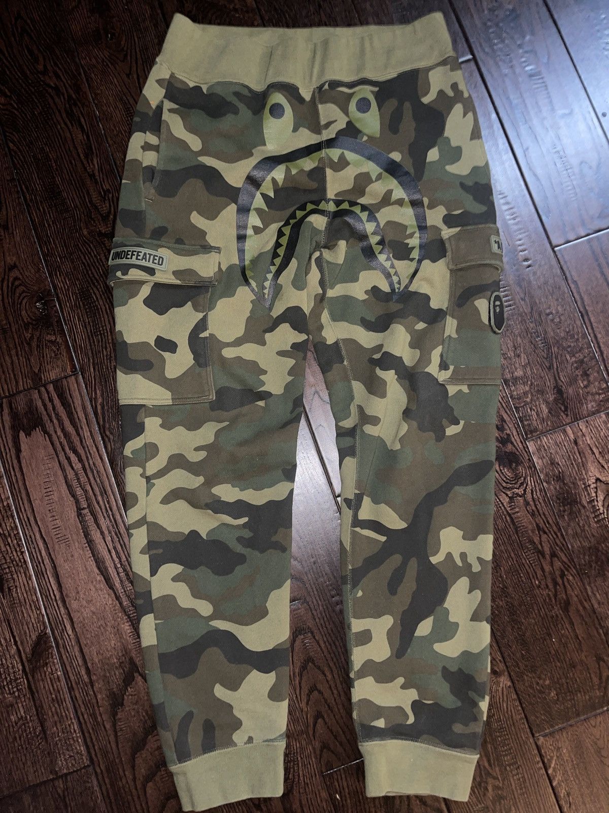 image of Bape x Undefeated Woodland Camo Shark Sweat Pants in Green, Men's (Size 30)