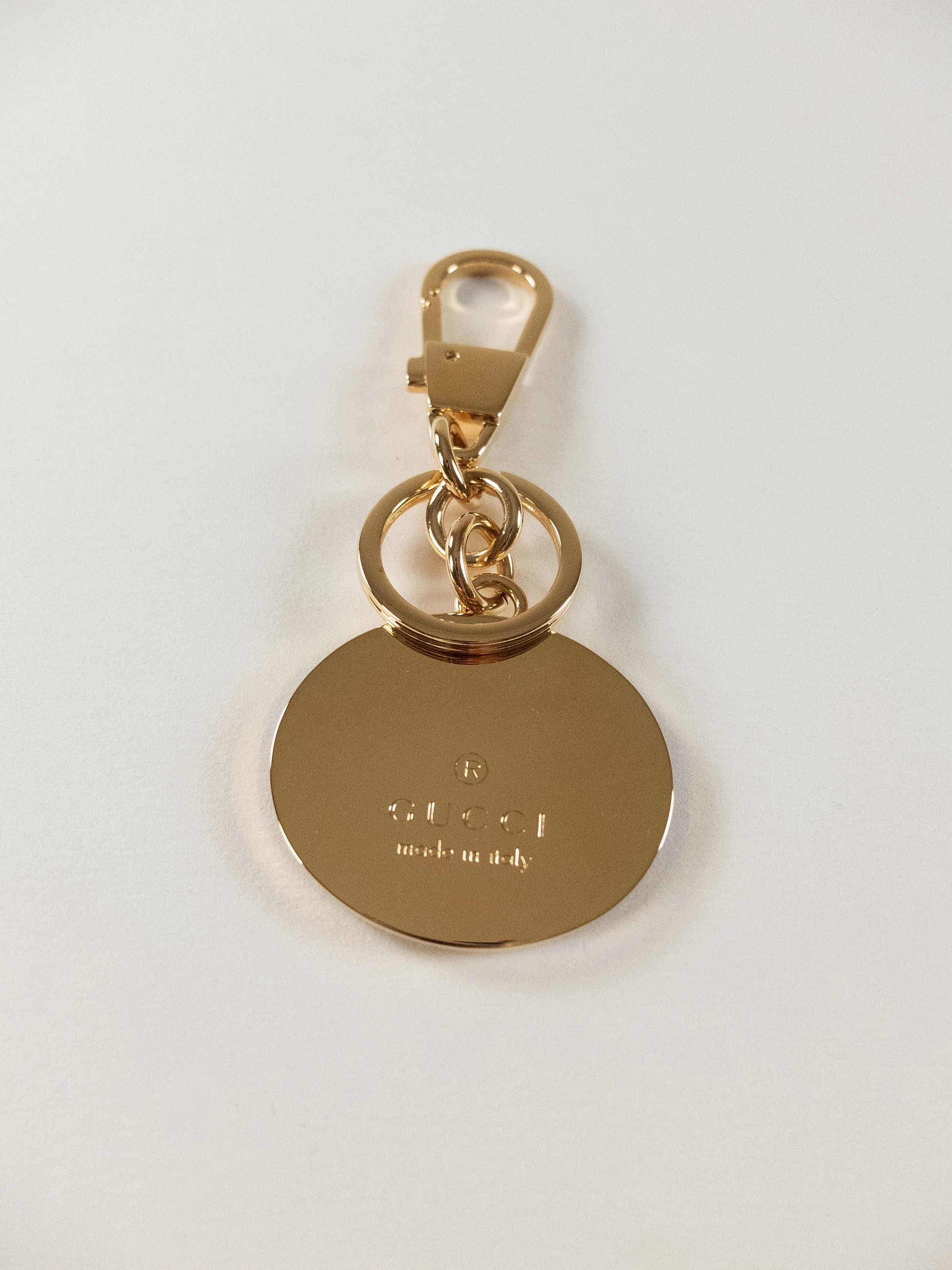 GUCCI gold tone enameled interlocking G logo metal keyring