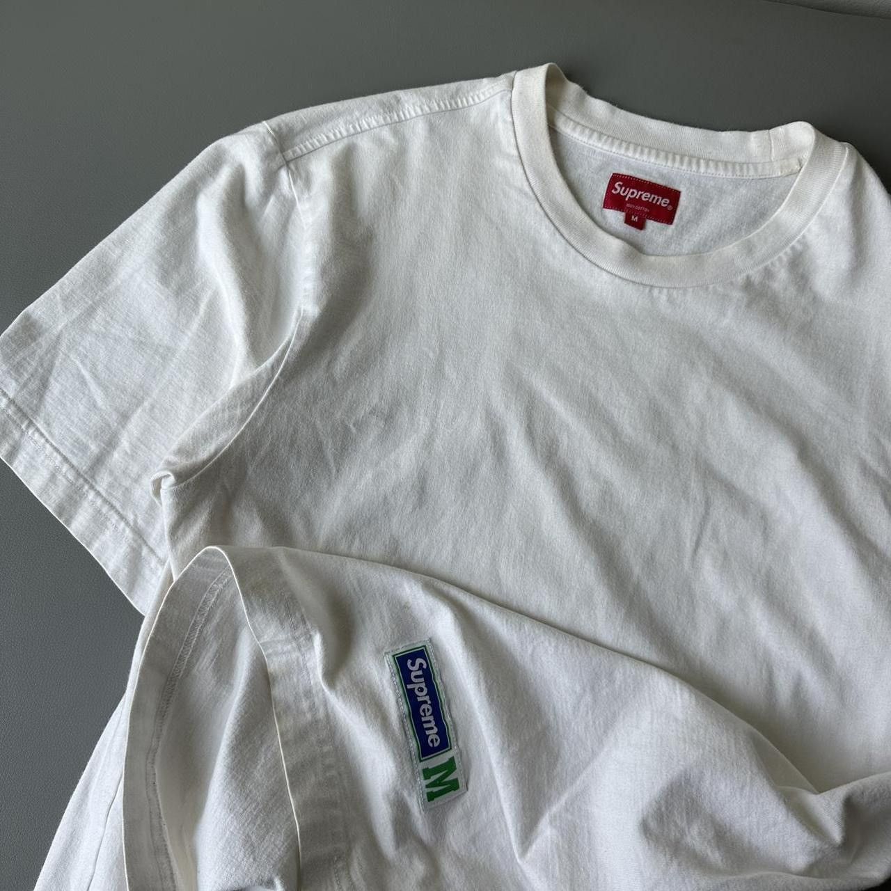 Supreme t shirt label deals