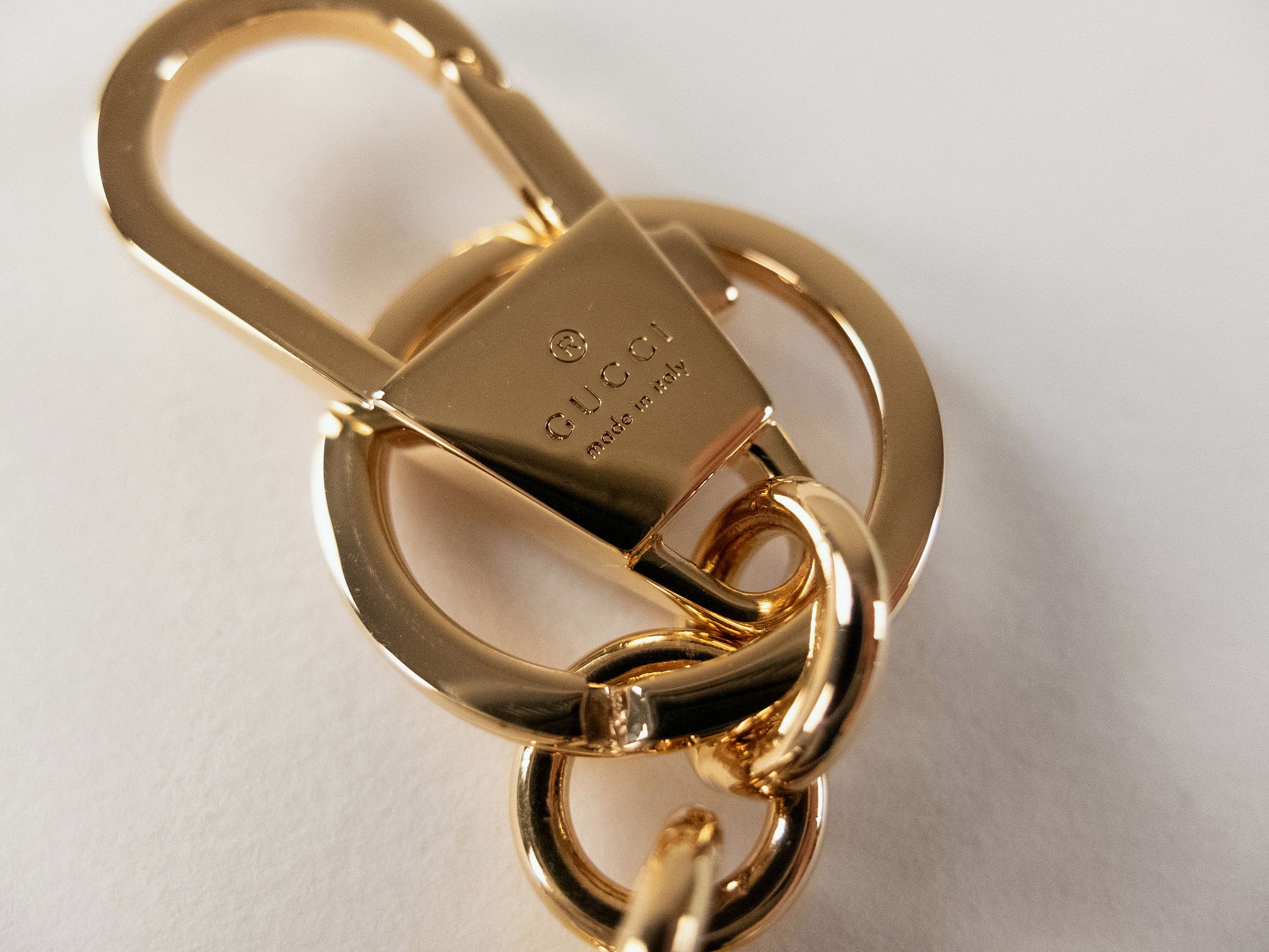 GUCCI gold tone enameled interlocking G logo metal keyring