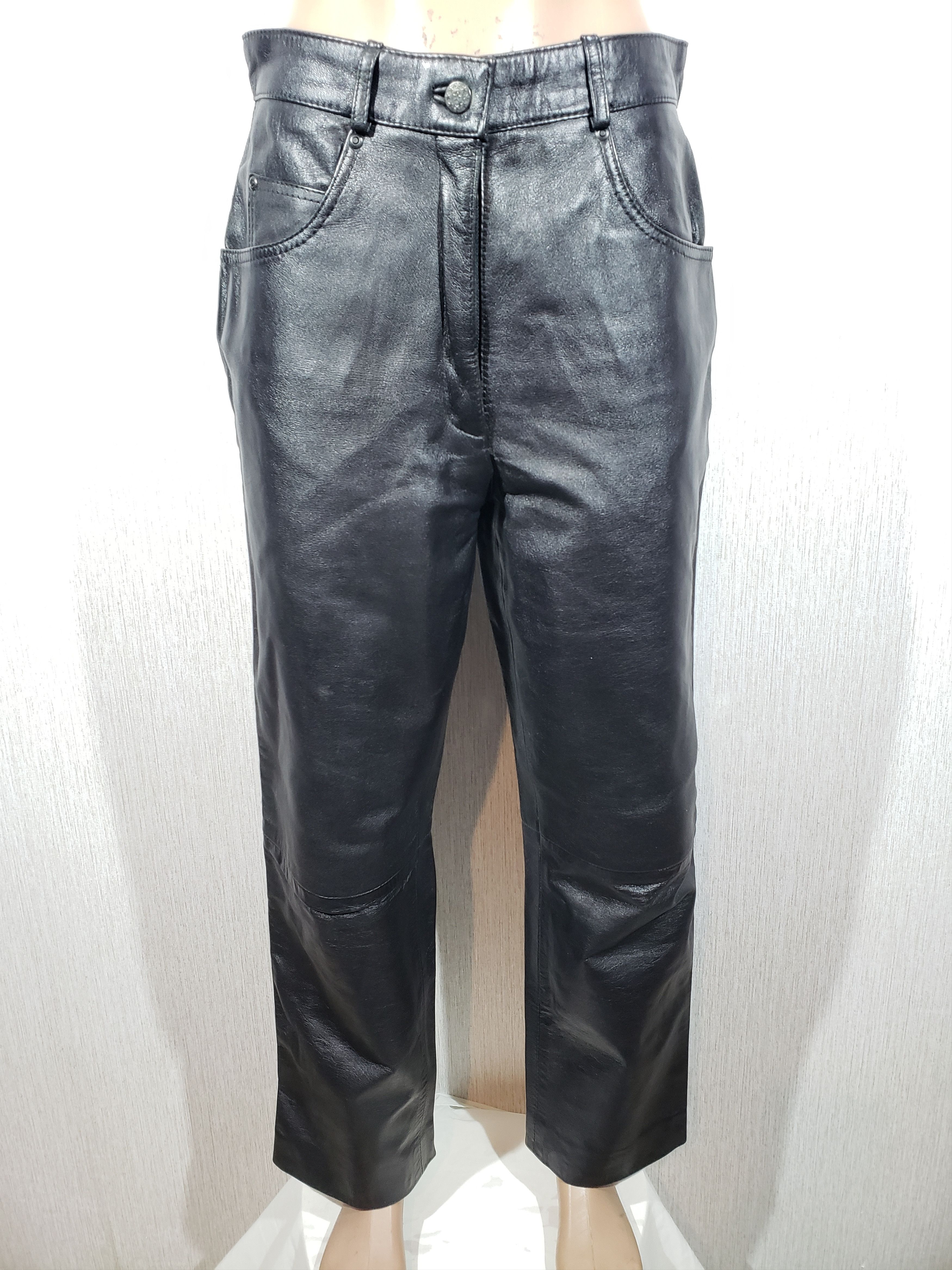 Stylish elegant women's black leather pants.