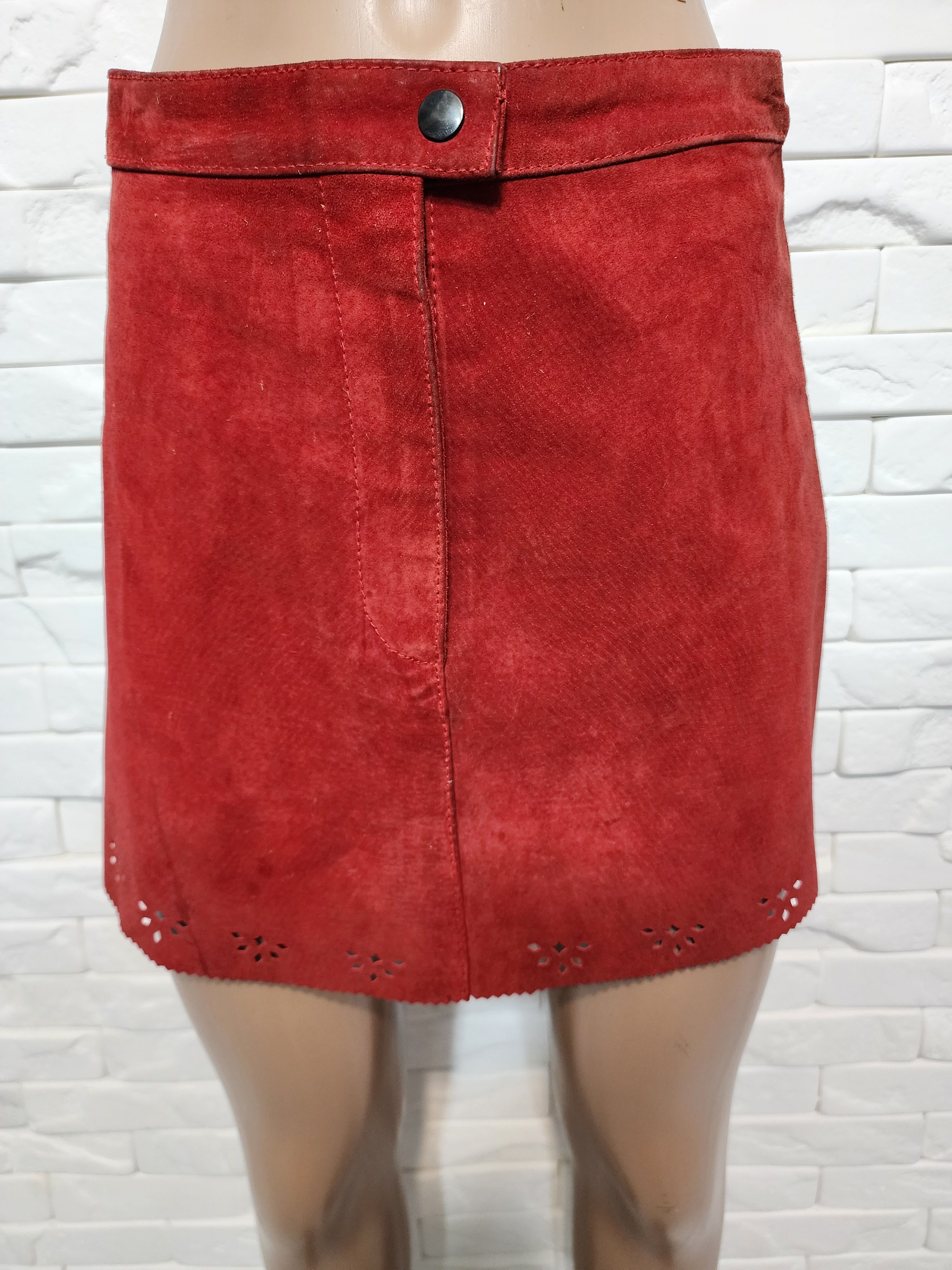 Red skirt made of genuine suede with perforation.
