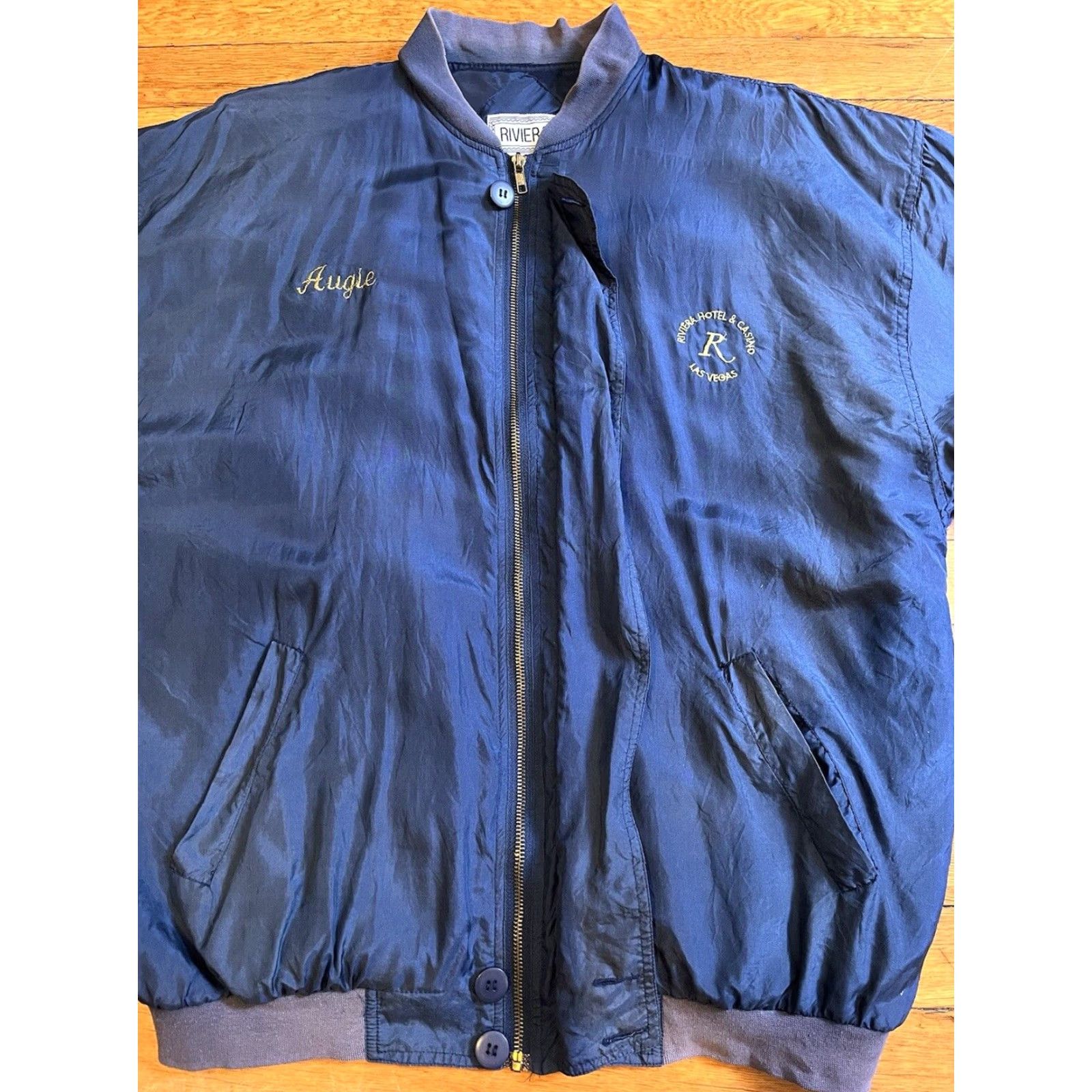 Rivieras VINTAGE Riviera Hotel & Casino Silk Jacket Men’s Large Blue Bomber Jacket Short Chest 48 in Embroidered AUGIE Mens 80s City Retro Money Size US L / EU 52-54 / 3 - 5 Thumbnail