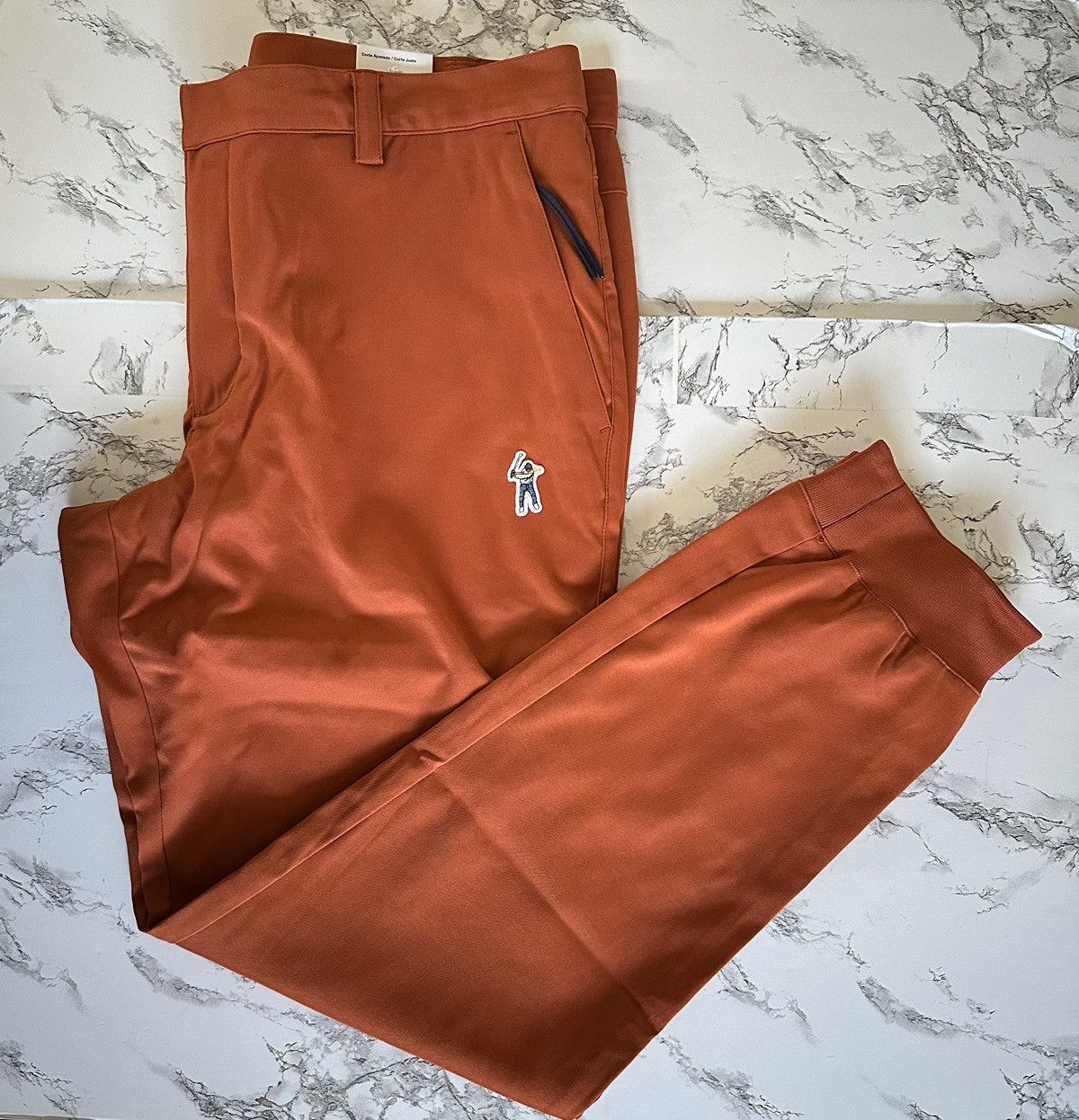 image of Air Jordan X Eastside Golf Tapered Embroidered Golf Pants in Orange, Men's (Size 36)