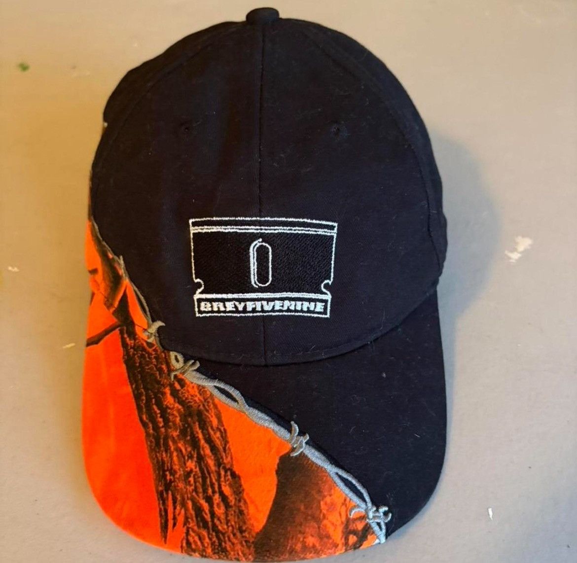 G59 Records G59 black/orange split razor barb hat | Grailed