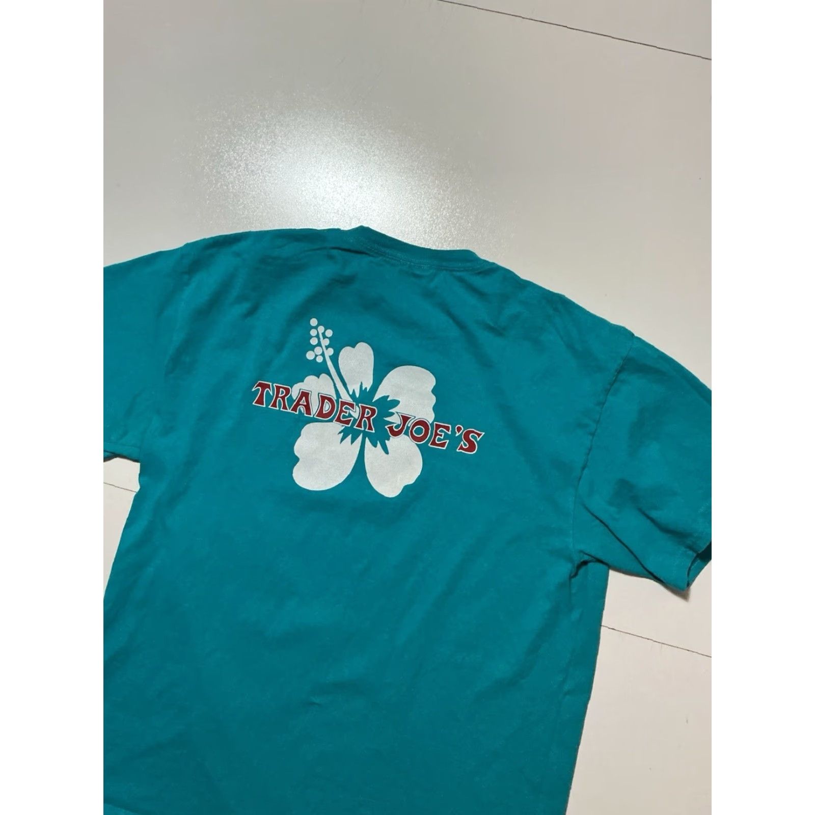 Port & Company VINTAGE Trader Joes Grocery Store Hibiscus Flower Graphic Teal S/S Employee Team Member T-Shirt Sz.L Size US L / EU 52-54 / 3 - 5 Thumbnail