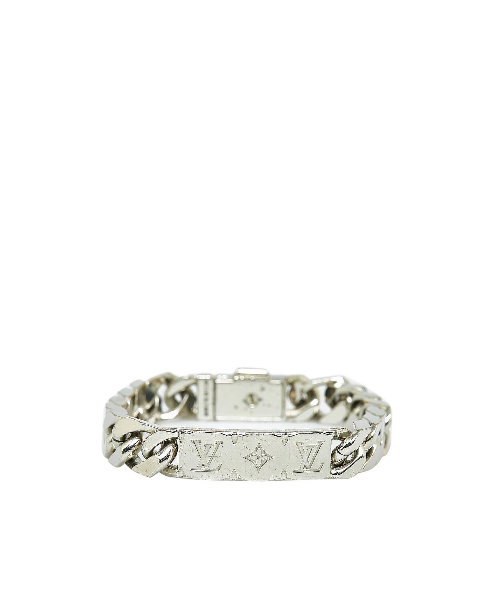 Sold at Auction: LOUIS VUITTON, A MONOGRAM BRACELET in 18ct white gold, the  fine link chain suspending a series of LV