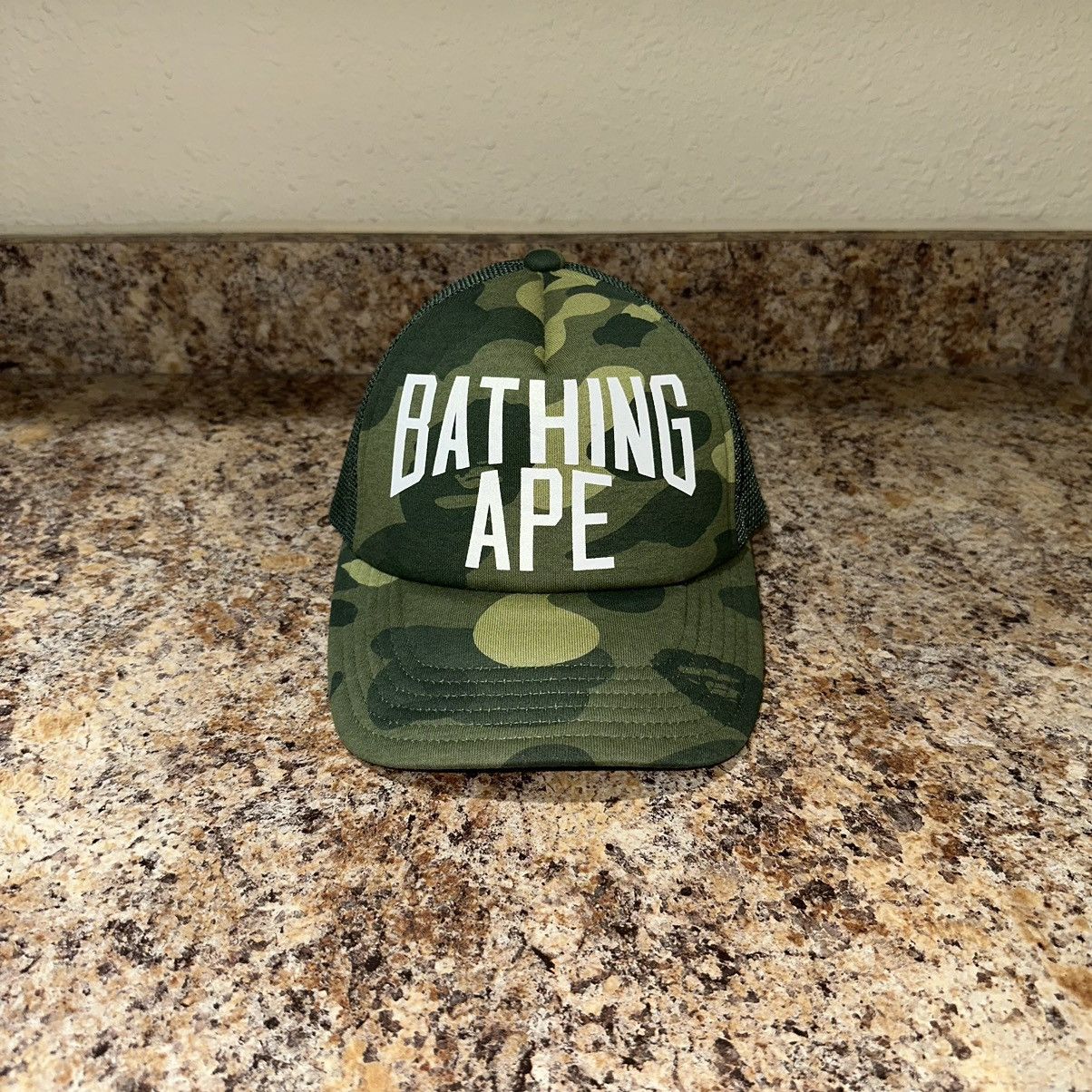 image of Bape A Bathing Ape First Camo Trucker Hat in Green, Men's