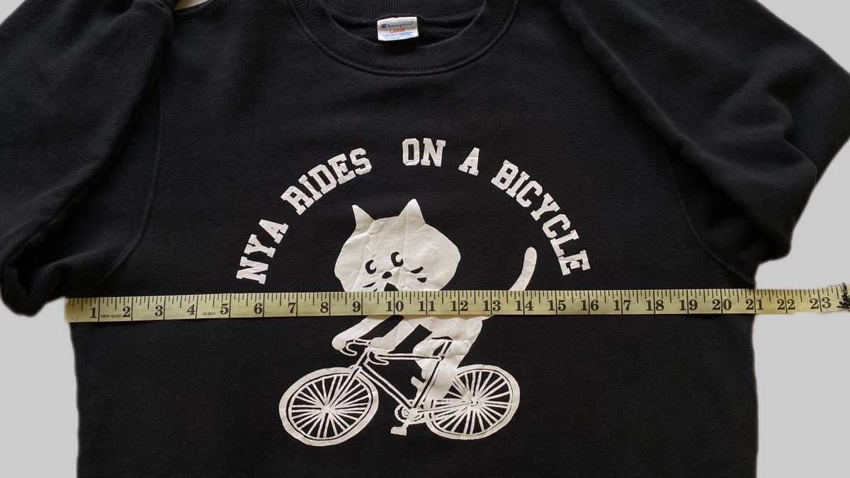 Champion × Ne-Net VTG Ne-Net x Champion “Nya Rides on a Bicycle” Size US L / EU 52-54 / 3 - 5 Thumbnail