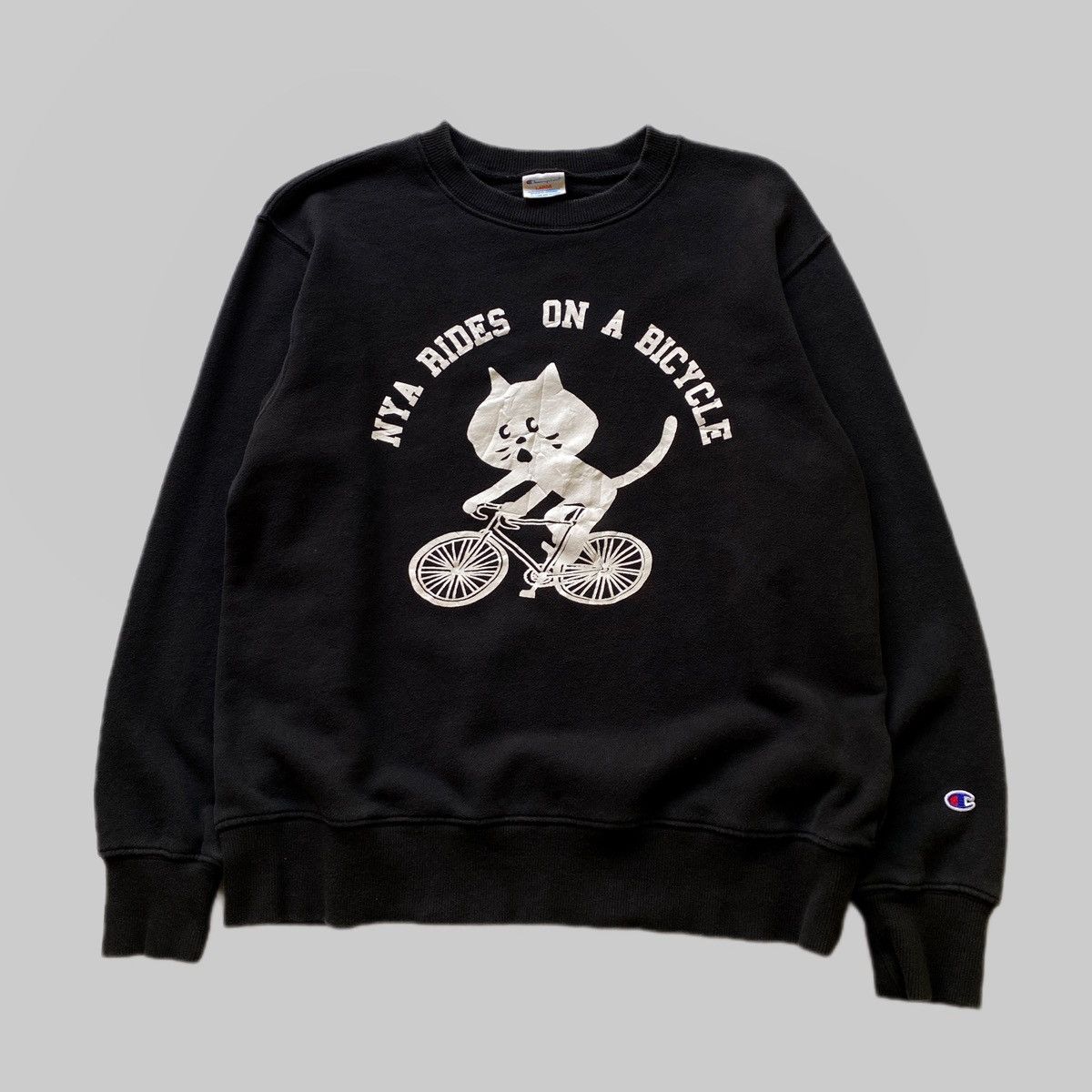 Champion × Ne-Net VTG Ne-Net x Champion “Nya Rides on a Bicycle” Size US L / EU 52-54 / 3 - 1 Thumbnail